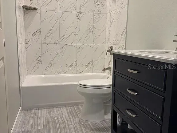 a bathroom with a toilet a sink and bathtub