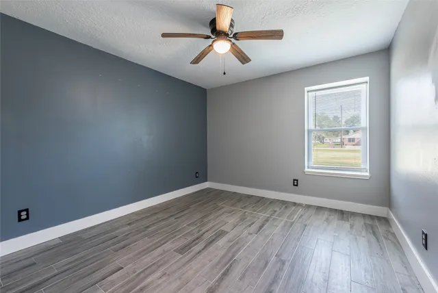 wooden floor in an empty room with a window