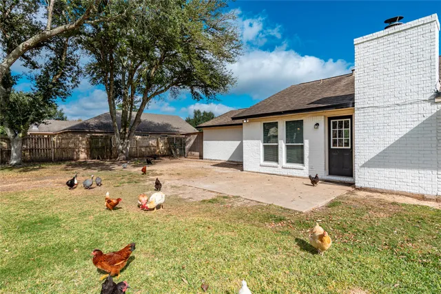 a white house that has a tree in front of it
