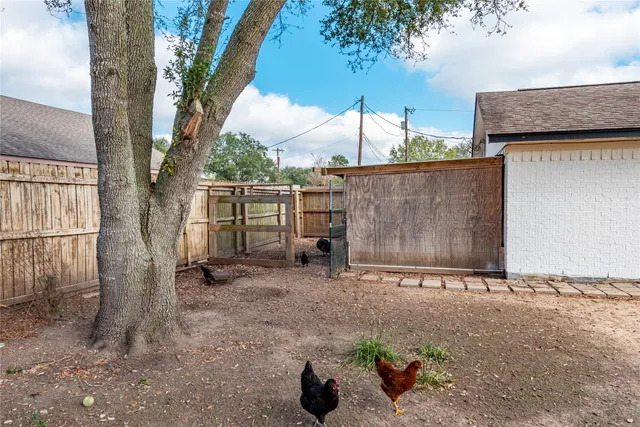 a backyard of a house with table and chairs