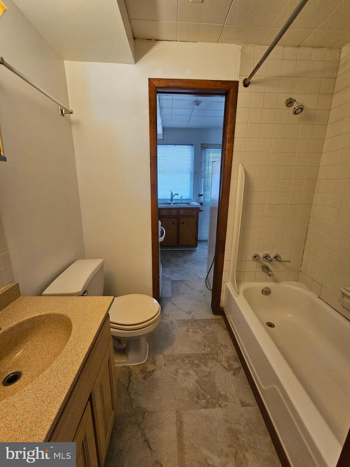 303 Delaware Circle, Unit 4 Newark, DE 19711 - Photo 11 of 14 a bathroom with a sink a toilet and shower