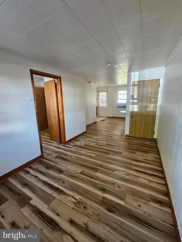 a view of a room with wooden floor