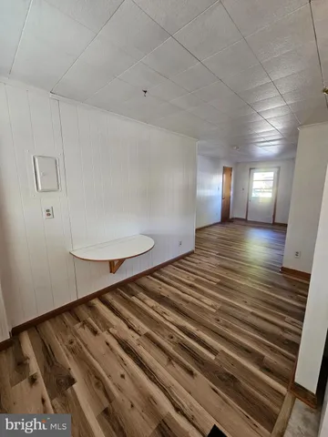 a view of a room with wooden floor