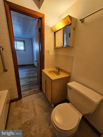 a white toilet sitting next to a bathroom sink