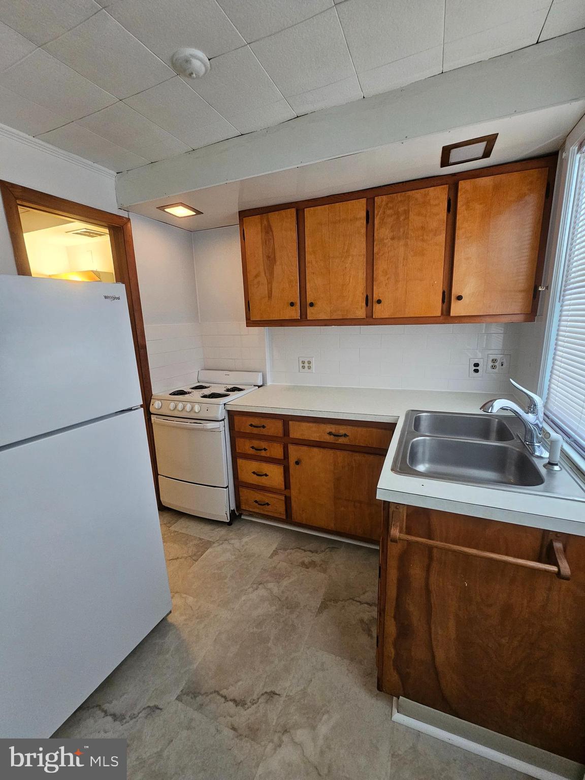 303 Delaware Circle, Unit 4 Newark, DE 19711 - Photo 9 of 14 a kitchen with a sink a stove and a refrigerator