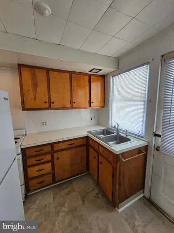 a kitchen with stainless steel appliances granite countertop a sink and a stove