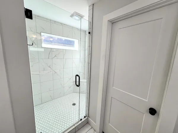 a bathroom with a shower and a sink