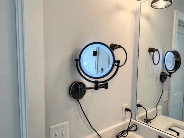 a bathroom with a toilet and a mirror