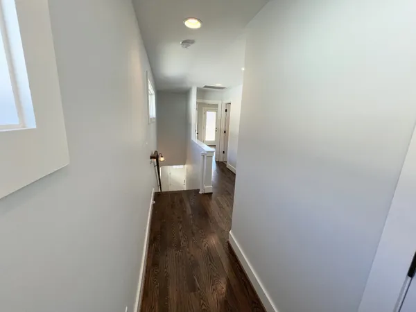 a view of a hallway with a large mirror