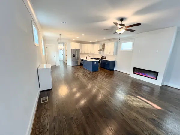a view of kitchen and hall with wooden floor