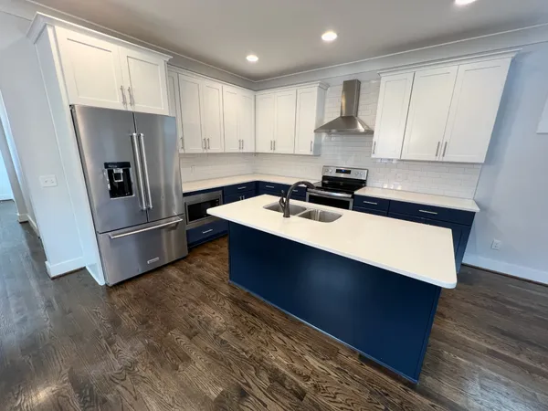 a kitchen with a refrigerator sink and cabinets