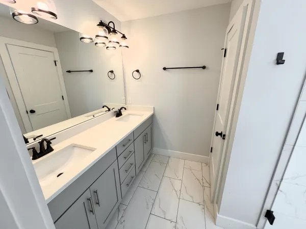 a bathroom with a sink vanity and shower