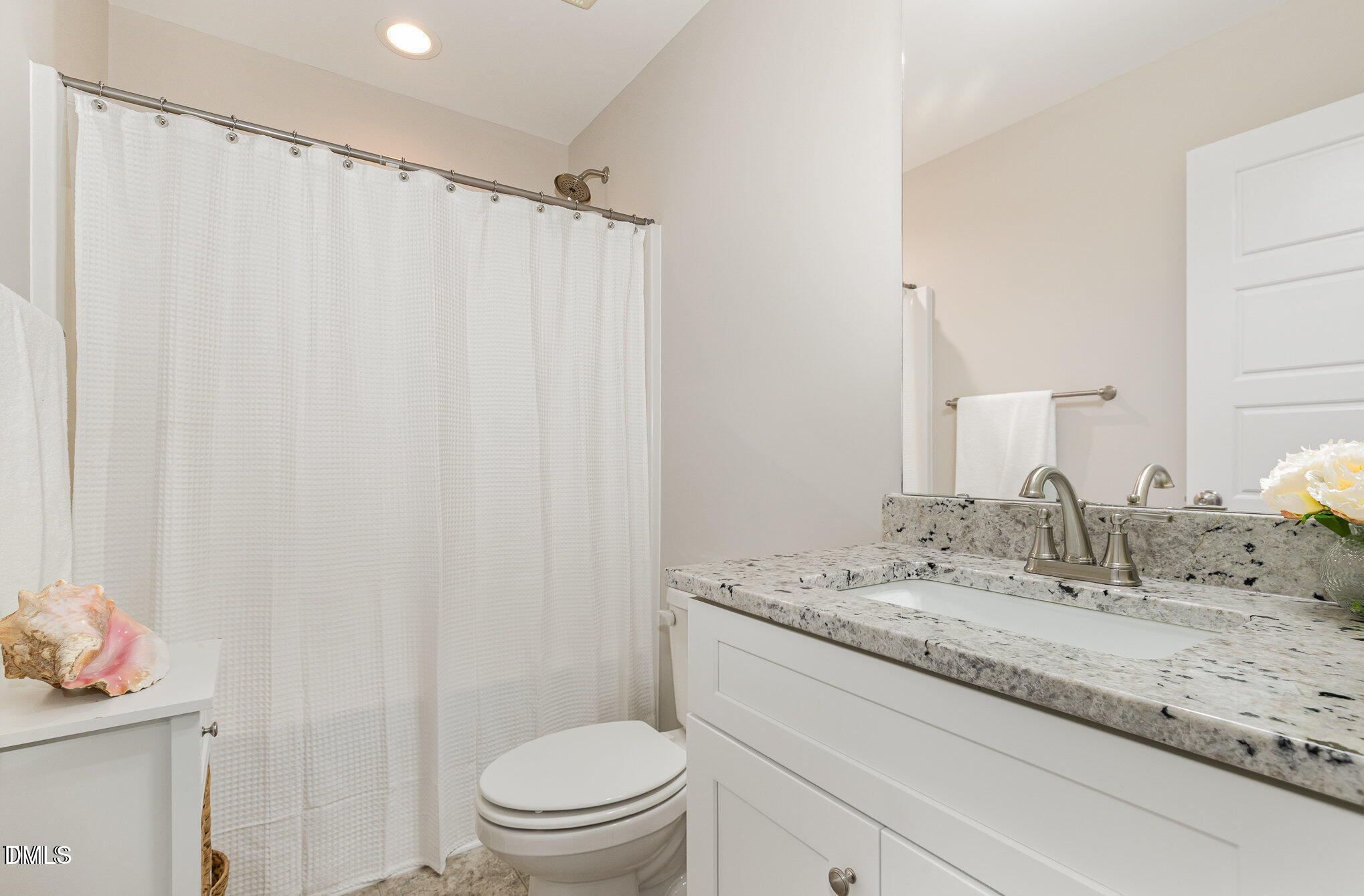 8662 Buckhorn Plantation Road Sims, NC 27880 - Photo 12 of 37 a bathroom with a granite countertop sink and a mirror