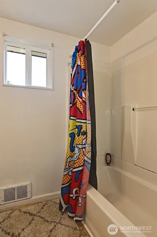 a bathroom with a bathtub and a shower