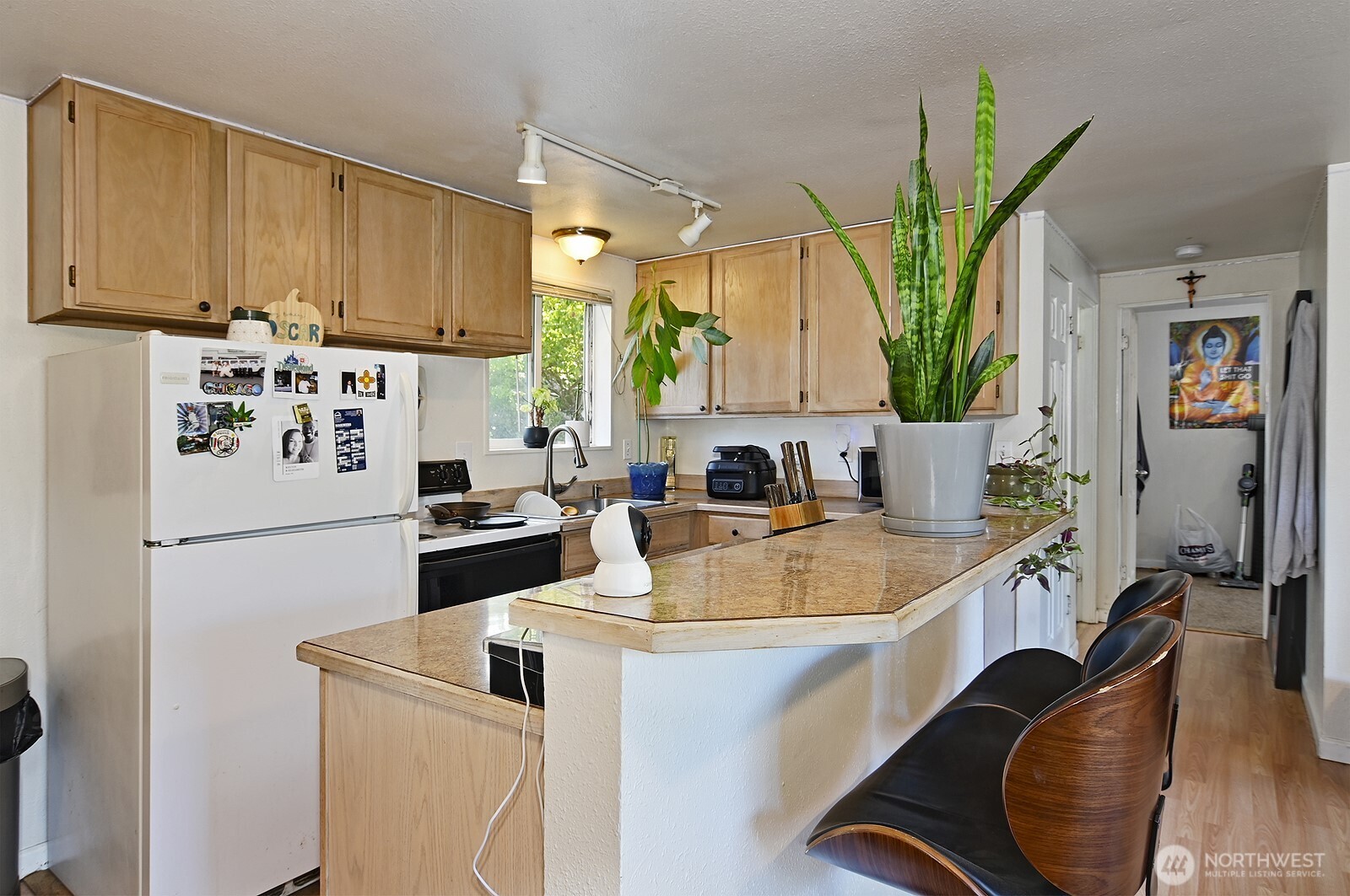 15002 4th Avenue South Burien, WA 98148 - Photo 20 of 30 a kitchen with stainless steel appliances a sink a refrigerator a counter space and a dining table