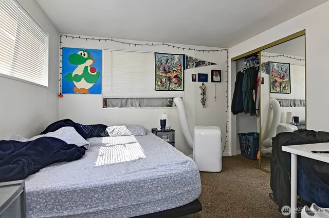 a bedroom with a bed and dresser