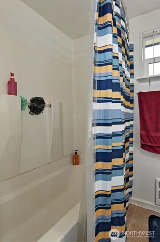 a bathroom with a bathtub and a shower
