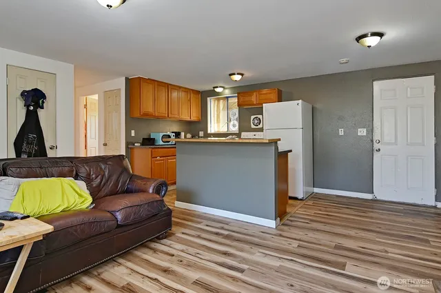 a living room with kitchen and furniture
