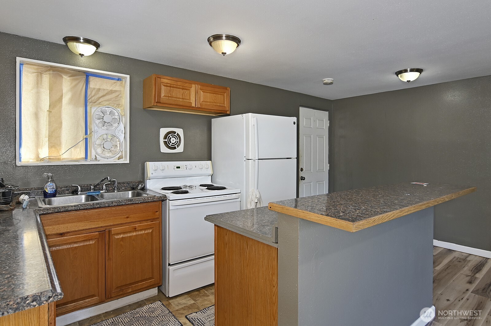 15002 4th Avenue South Burien, WA 98148 - Photo 10 of 30 a kitchen with stainless steel appliances granite countertop a refrigerator stove top oven sink and cabinets