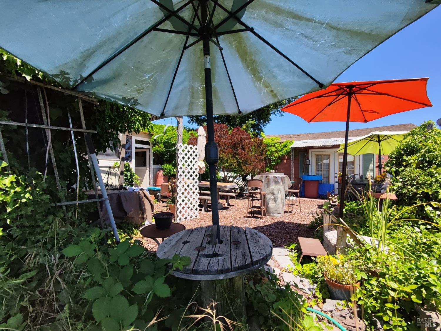 148 Millbrae Avenue Santa Rosa, CA 95407 - Photo 27 of 29 a view of patio with chairs and table under an umbrella