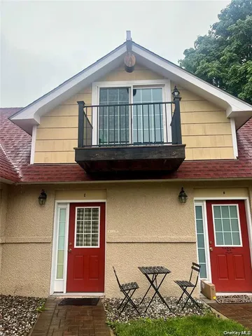 a view of a brick house with large windows