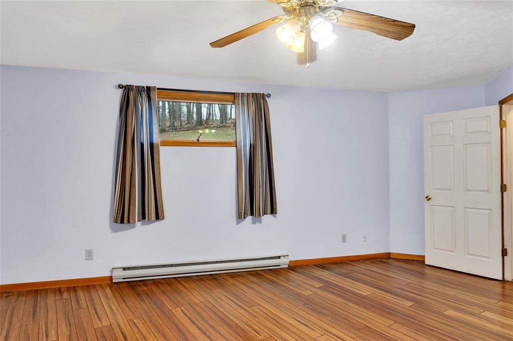 173 Harvey Road Sarver, PA 16055 - Photo 21 of 25 an empty room with wooden floor fan and windows