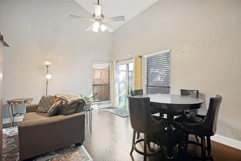 a living room with furniture a chandelier and a large window