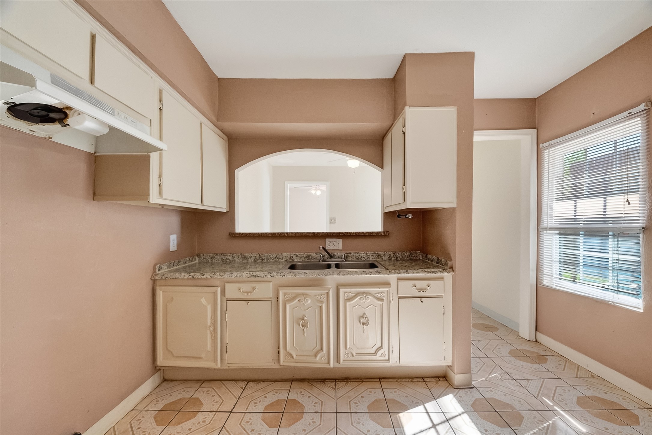 968 Garapan Street Houston, TX 77091 - Photo 16 of 40 a kitchen with a stove a sink and cabinets