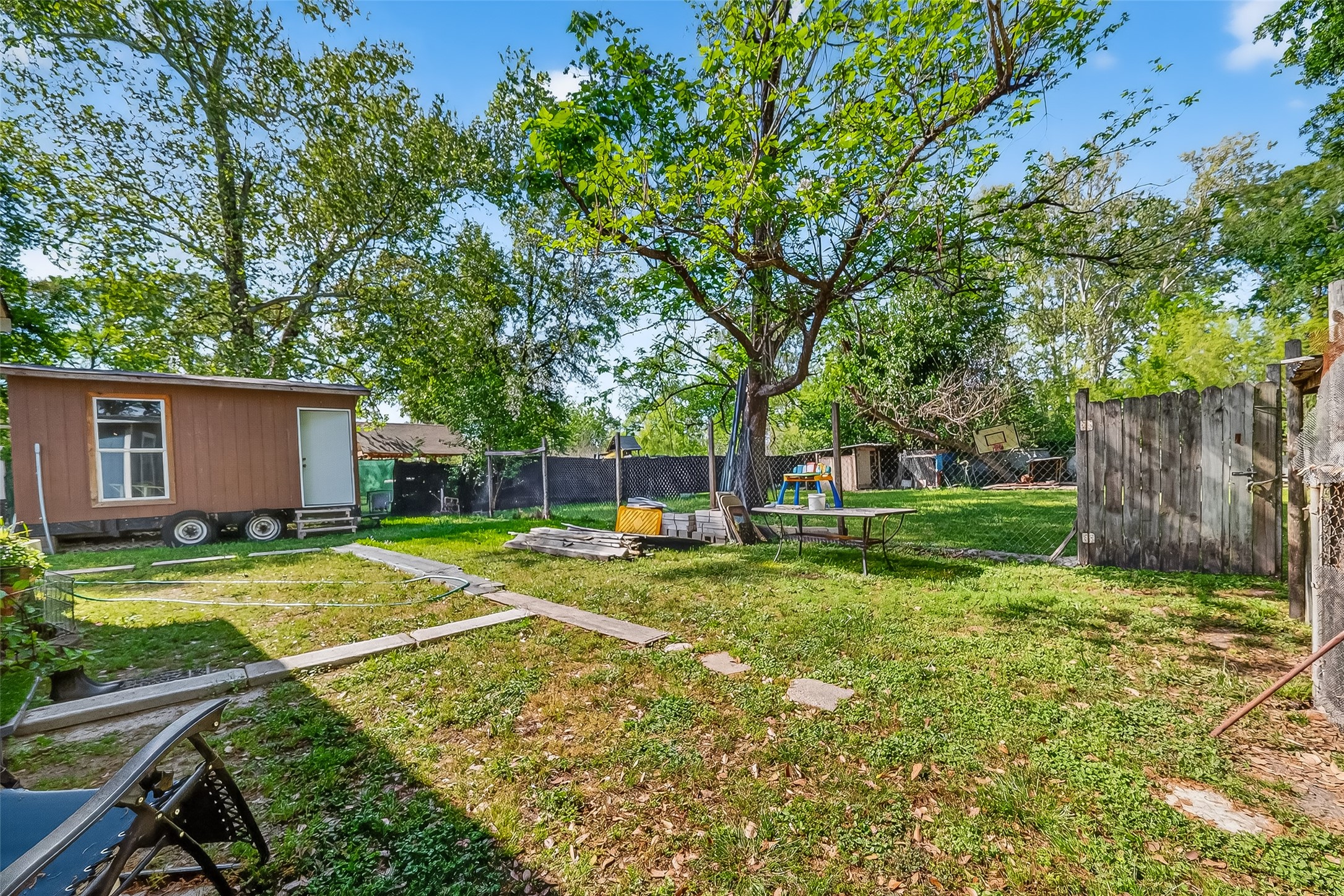 968 Garapan Street Houston, TX 77091 - Photo 33 of 40 a view of a backyard with a garden and trees
