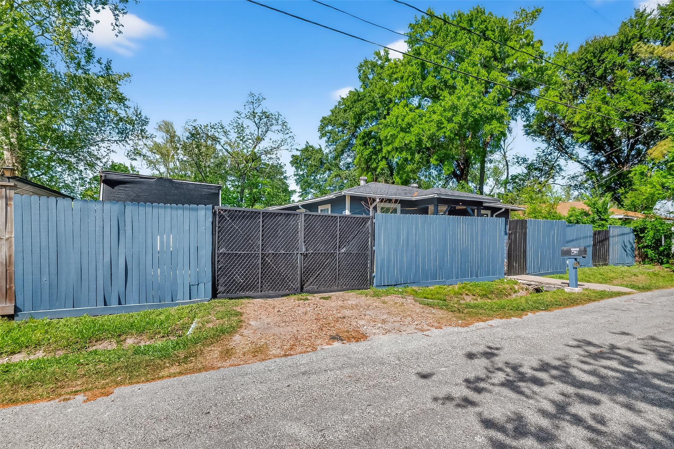 968 Garapan Street Houston, TX 77091 - Photo 4 of 40 a view of a backyard with large trees and wooden fence
