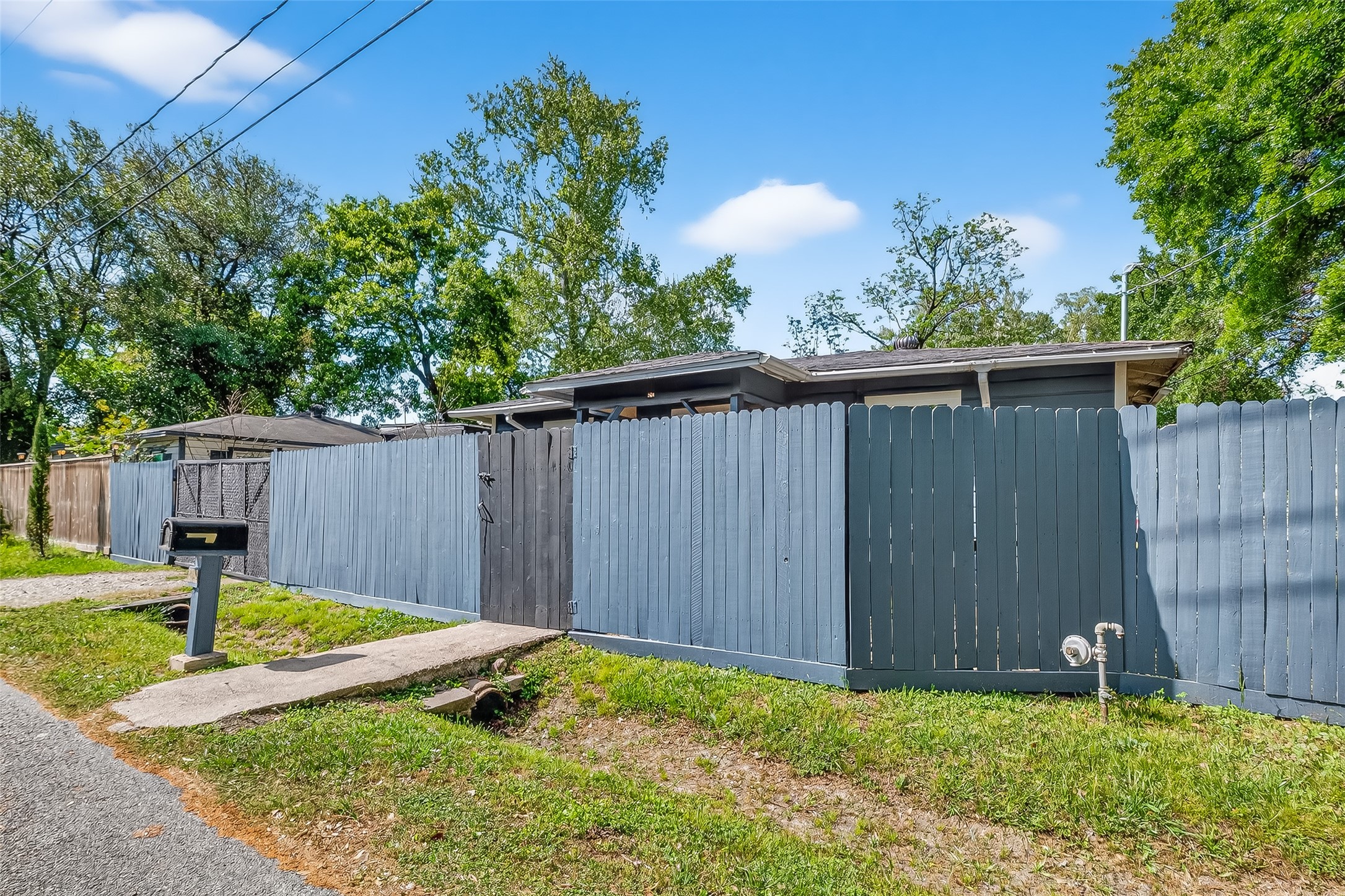 968 Garapan Street Houston, TX 77091 - Photo 5 of 40 a view of backyard with wooden fence and a bench