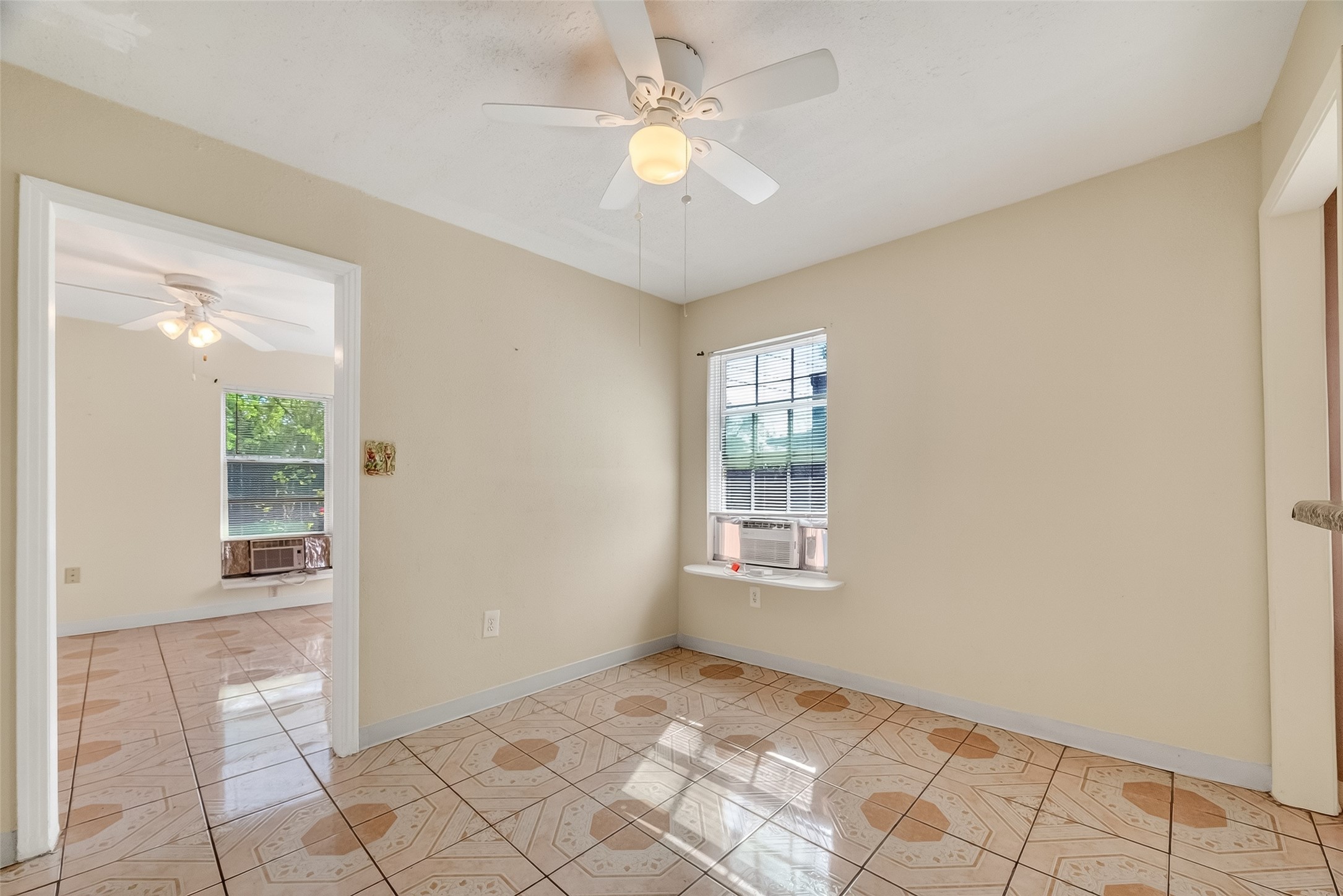 968 Garapan Street Houston, TX 77091 - Photo 10 of 40 a view of an empty room with window and chandelier fan