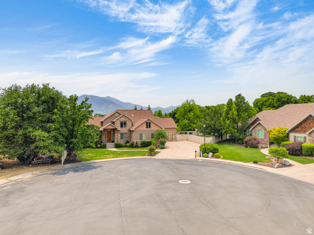 1279 West 1500th Street North Mapleton, UT 84664 - Photo 72 of 83 Stone and stucco residence featuring a prominent gabled roofline and lush front landscaping
