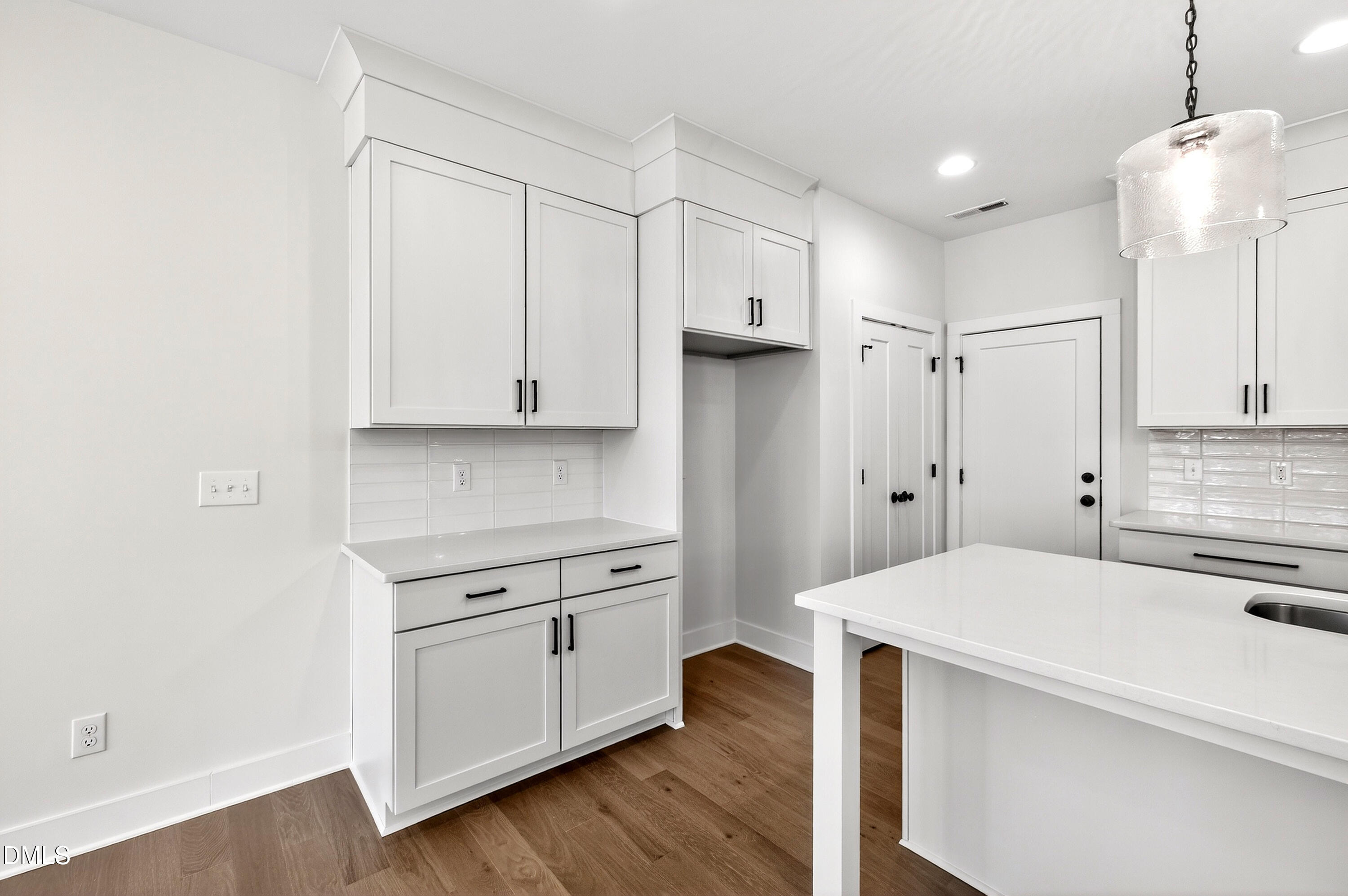 976 Double Helix Road Apex, NC 27523 - Photo 13 of 50 a kitchen with white cabinets and stainless steel appliances