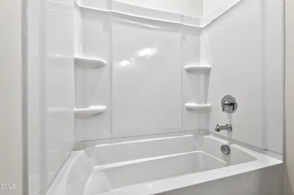 a white bath tub sitting next to a white sink
