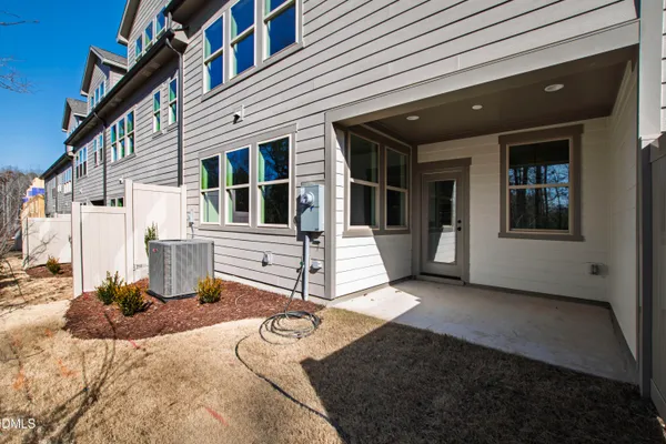 a view of a house with backyard and parking