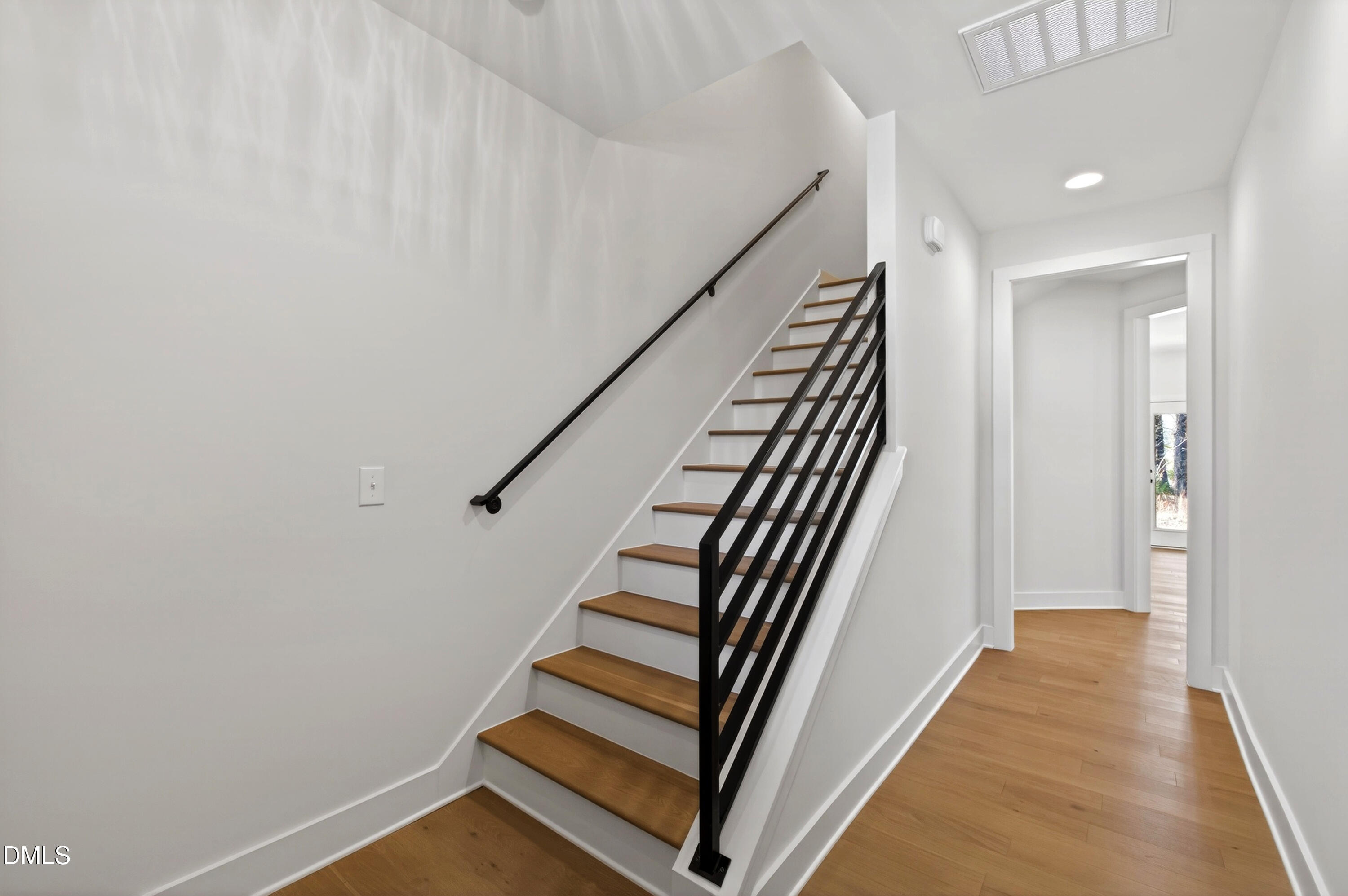 976 Double Helix Road Apex, NC 27523 - Photo 7 of 50 a view of a hallway with wooden floor and stairs