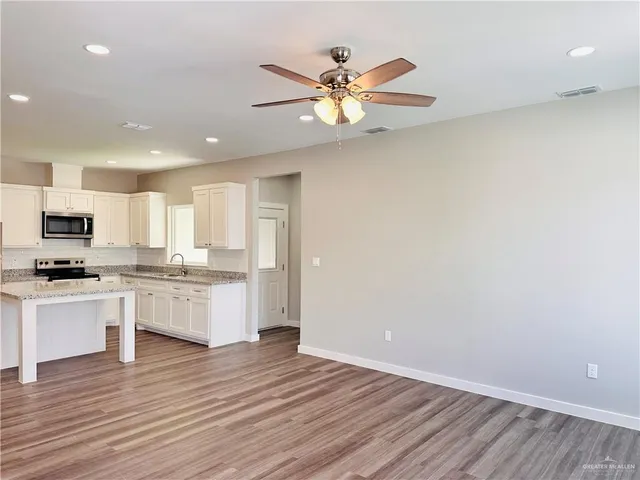 a view of kitchen with sink and wooden floor