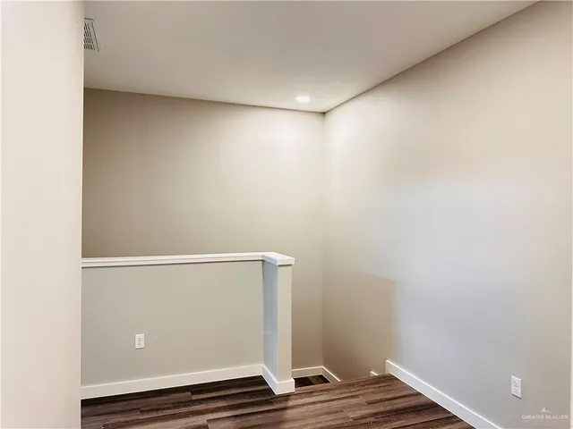 a bathroom with a granite countertop sink and a toilet