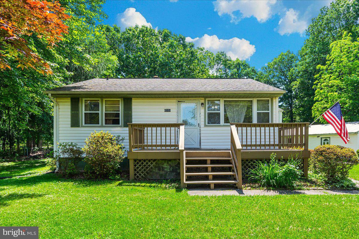 6109 Ford Road Frederick, MD 21702 - Photo 1 of 59 a backyard of a house with potted plants and large tree