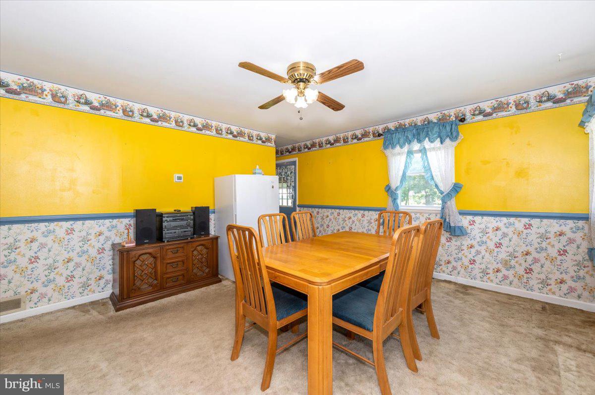 6109 Ford Road Frederick, MD 21702 - Photo 16 of 59 a view of a dining room with furniture and a large window