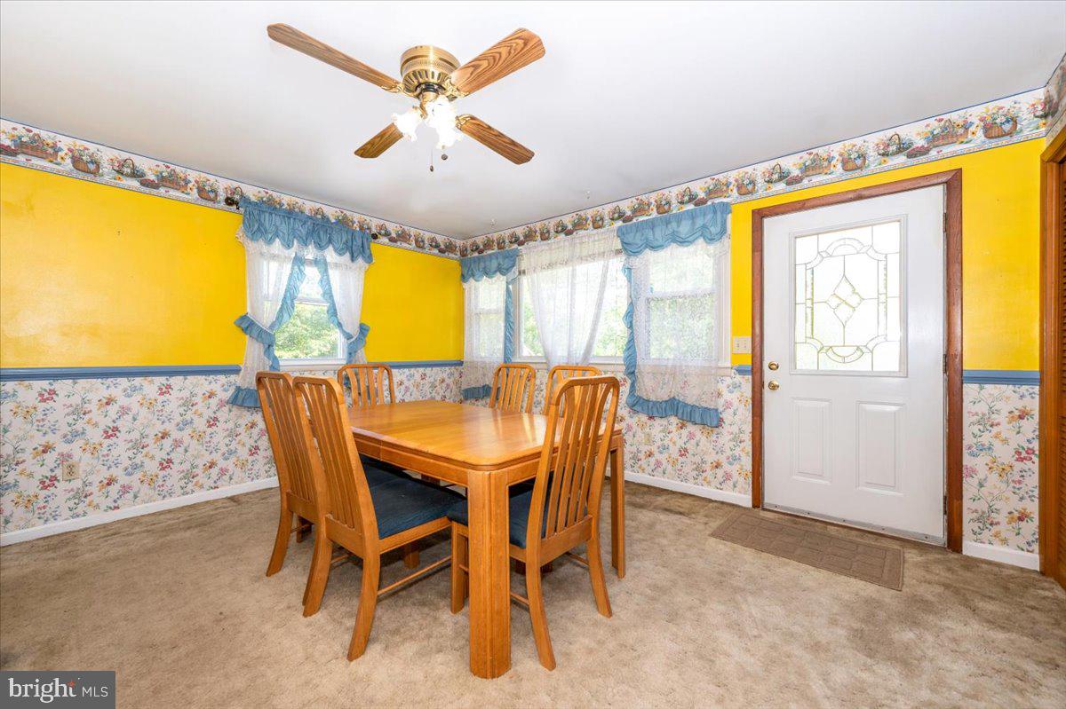 6109 Ford Road Frederick, MD 21702 - Photo 19 of 59 a view of a dining room with furniture and a chandelier