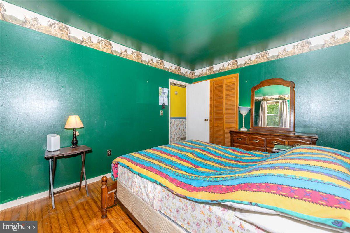 6109 Ford Road Frederick, MD 21702 - Photo 29 of 59 a bedroom with a bed and a lamp