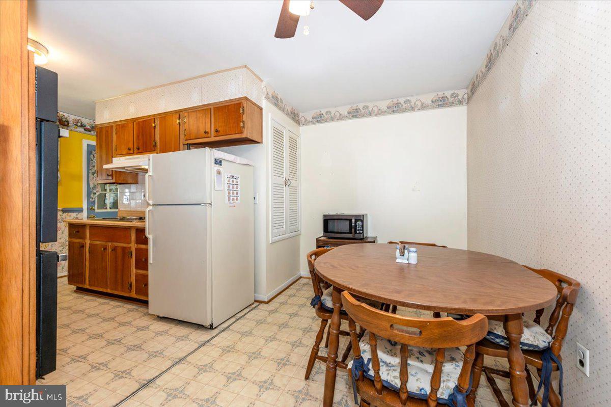 6109 Ford Road Frederick, MD 21702 - Photo 7 of 59 a kitchen with a appliances a refrigerator and a table