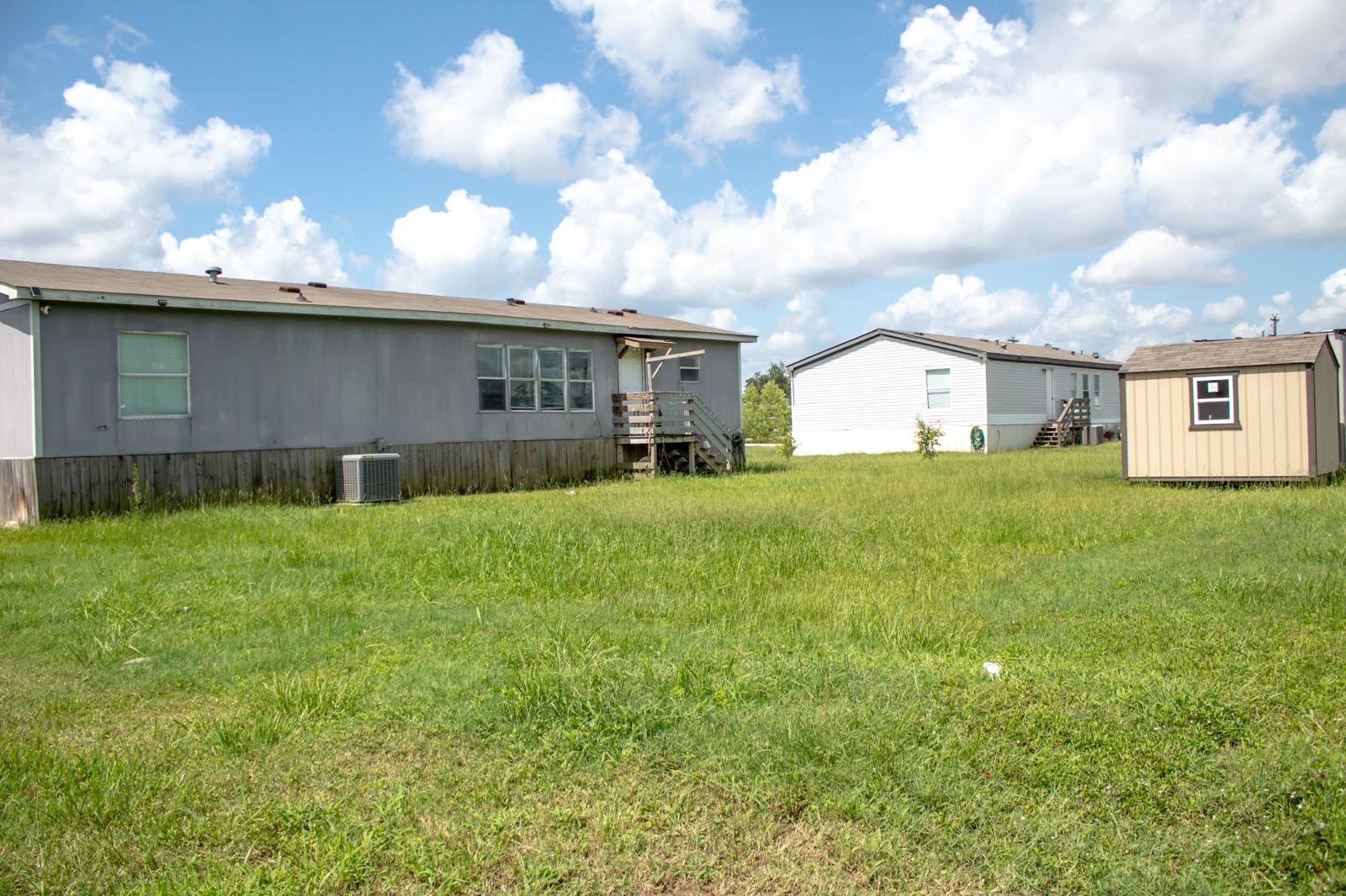 8021 Matthew Steven Drive Conroe, TX 77306 - Photo 21 of 24 a view of a yard with a house in the background