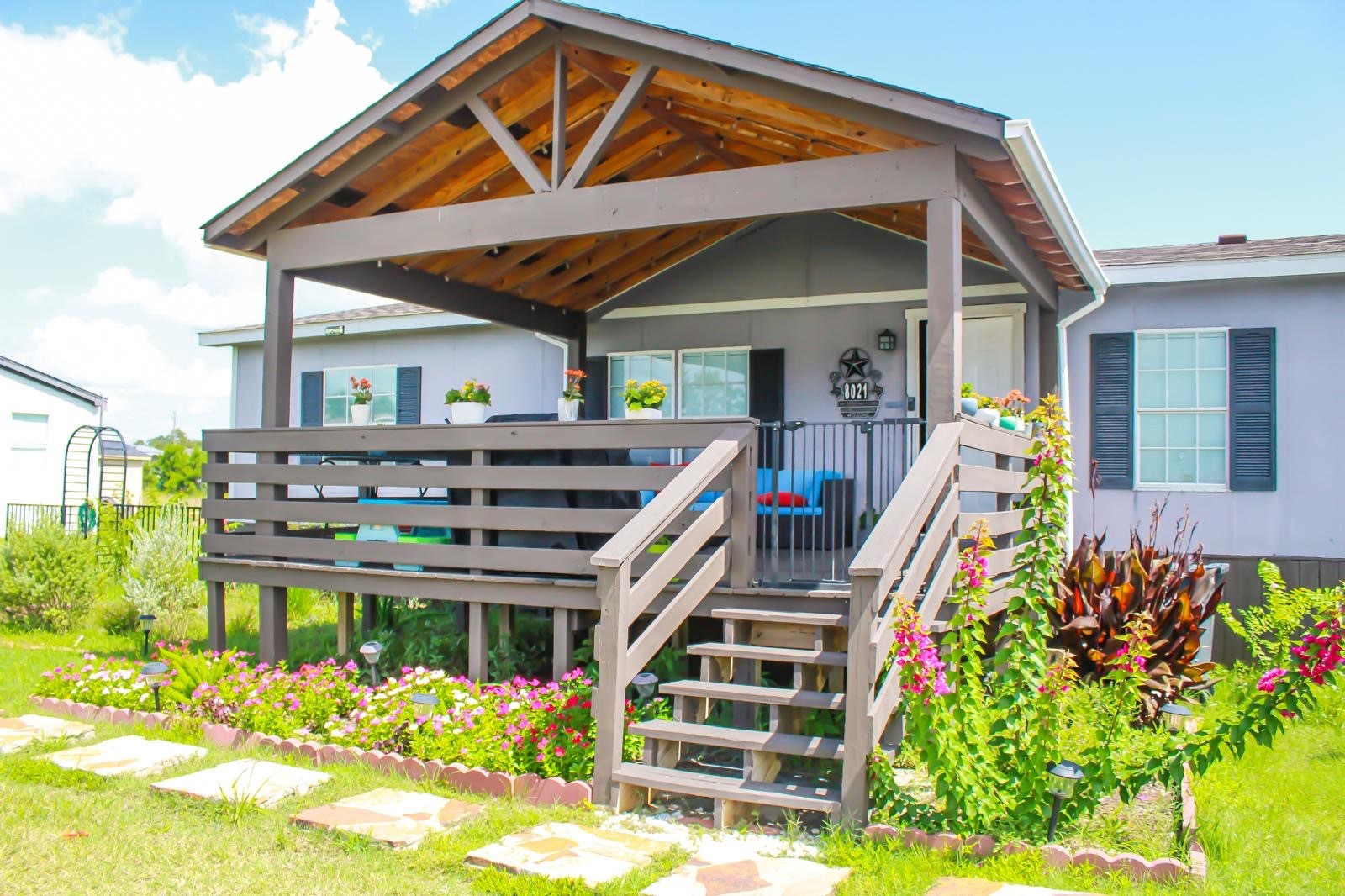 8021 Matthew Steven Drive Conroe, TX 77306 - Photo 4 of 24 a view of a house with wooden deck and furniture