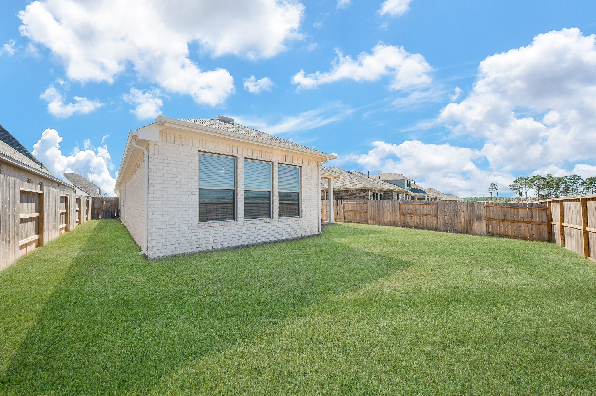 42514 Summer Crst Road Magnolia, TX 77354 - Photo 49 of 50 a view of a backyard with plants and a large tree