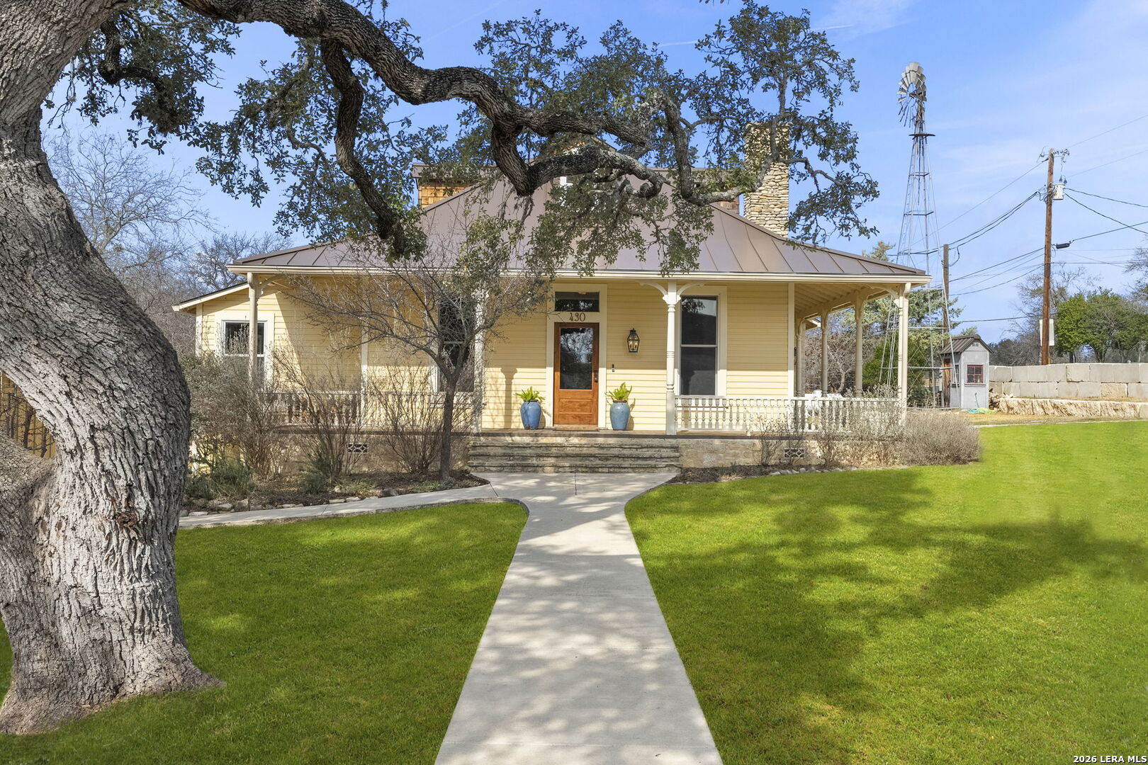 107 High Street Comfort, TX 78013 - Photo 2 of 47 a front view of a house with garden