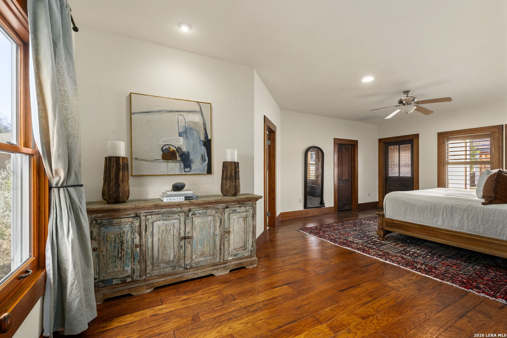 107 High Street Comfort, TX 78013 - Photo 21 of 47 a spacious bedroom with a bed and wooden floor