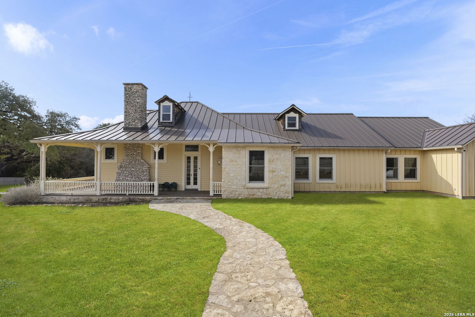 107 High Street Comfort, TX 78013 - Photo 4 of 47 a front view of a house with a garden and porch